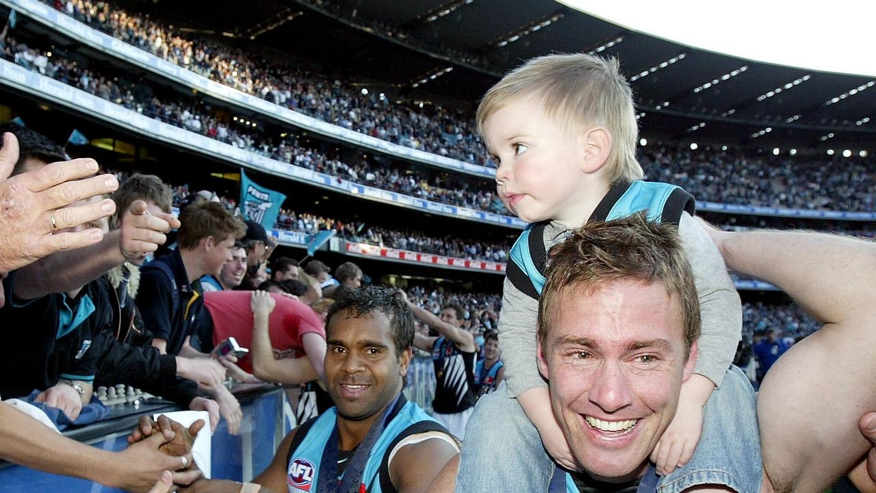 Port player Jarrad Schofield and his son Taj after the 2004 Grand Final.