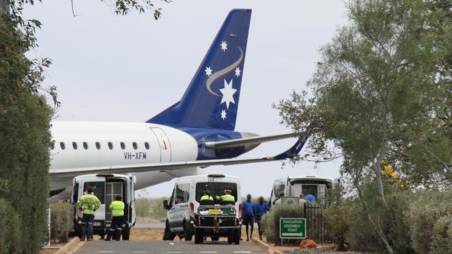 Male prisoners disembark a chartered flight from Darwin at Alice Springs Airport. Picture: Gera Kazakov