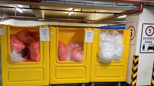 Bins containing linen from the Novotel/Ibis quarantine hotel stored in a residential carpark. Source: Supplied