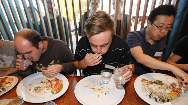 Ourimbah's Isaac Harding-Davis (centre) in the ultimate triumph for man, smashed his own sushi eating record last year.