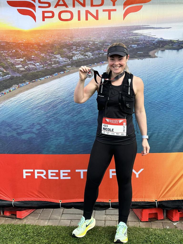 Nikki Ellison of Melbourne with her medal after completing her first half marathon.