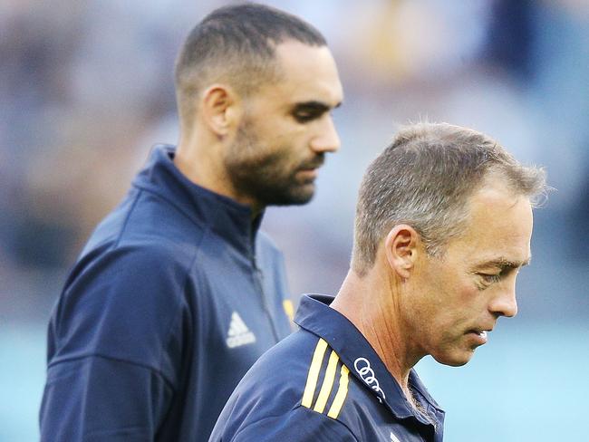 An injured Shaun Burgoyne leaves the ground with Hawthorn coach Alastair Clarkson. Picture: Getty Images