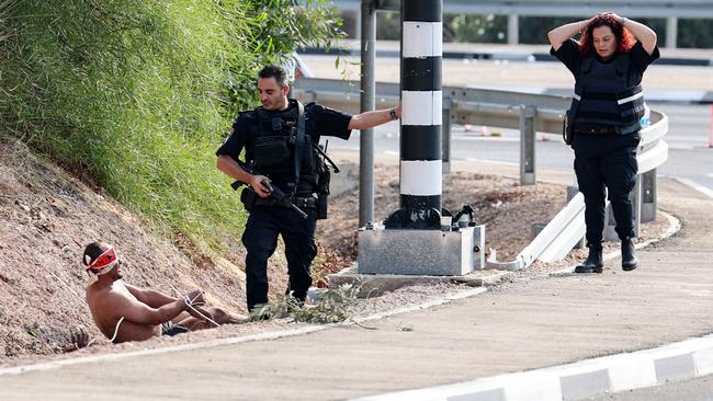 Israeli troops guard a Hamas fighter near Ashkelon on October 8. Picture: AFP