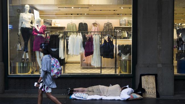 One homeless man sleeps beside the QVB this morning. Picture: Dylan Robinson