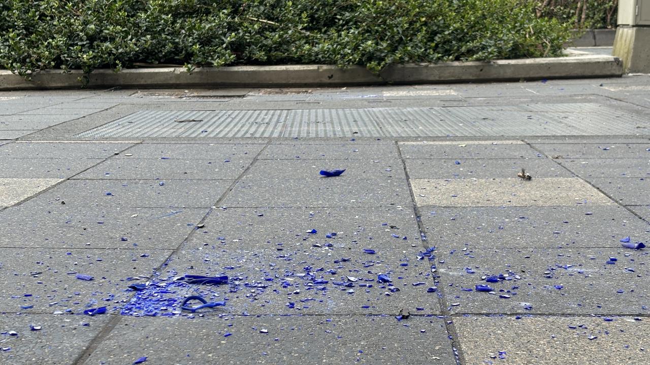 Pieces of blue glass were still on the ground after the Hilton sign fell off the building. Photo: Jacklyn O'Brien