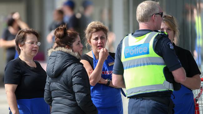 Police talk with Spotlight employees. Picture: Ian Currie