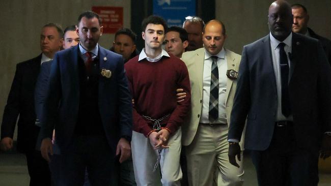 Luigi Mangione (C) arrives at Manhattan Criminal Court in New York. Mangione, 26, is accused of shooting UnitedHealthcare chief executive Brian Thompson on a Manhattan street on December 4.