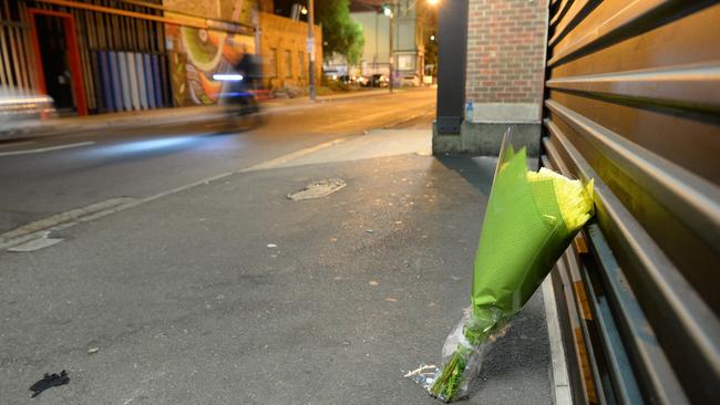 A young couple placed a bunch of flowers outside the nightclub door. Picture: Lawrence Pinder