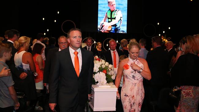 Parents Darren and Simone Tickle lead the casket at the funeral of Blake Tickell.