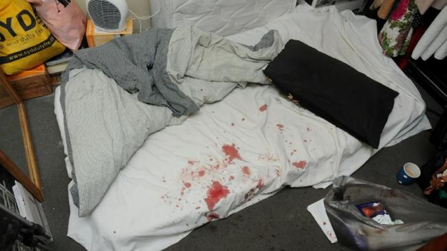 The bloodstained sheets of a bed in the unit were Daniel McNulty died.