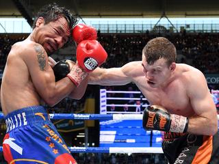 Jeff Horn of Australia (right) strikes Manny Pacquiao of the Phillipines during the WBO World Welterweight Title fight at Suncorp Stadium in Brisbane, Sunday, July 2, 2017. (AAP Image/Dave Hunt) NO ARCHIVING, EDITORIAL USE ONLY