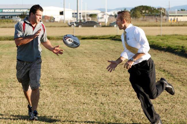 <p>Tony Abbott throws a ball around with Mackay Cutters player Neil Budworth , in Mackay , QLD. Picture: Lyndon Mechielsen</p>