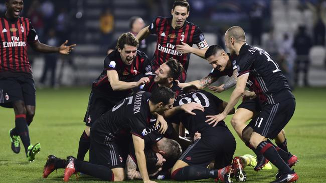 AC Milan players celebrate after winning the Italian Super Cup.