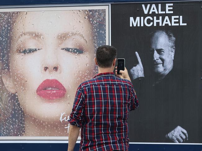 A fan takes a photo outside Rod Laver Arena after collecting his ticket. Picture: NCA NewsWire / Ian Currie