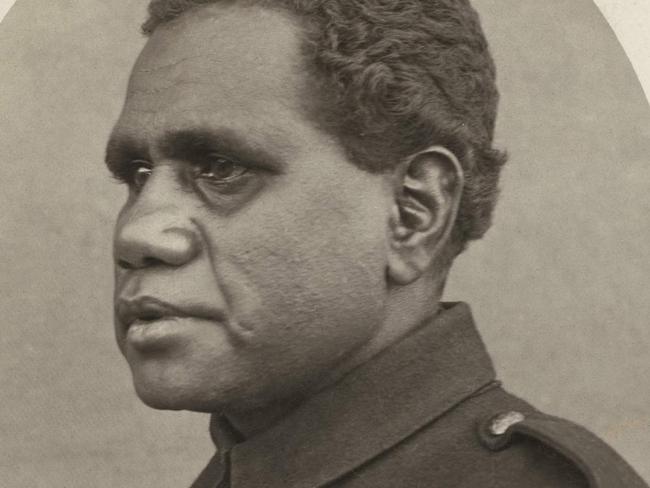 Studio portrait of Indigenous serviceman 6020 Private (Pte) Douglas Grant, 13th Battalion. On 11 April 1917, he was wounded and captured during the 1st battle of Bullecourt. He was held as a prisoner of war (POW) in a camp at Wittenberg, and later at Wünsdorf (Wuensdorf), Zossen. This image was taken while Pte Grant was a prisoner of war and held in captivity in Germany; he is wearing a British tunic sent over by the Red Cross to the Germans to outfit the POWs and dyed blue by the Germans. Please attribute Australian War Memorial..