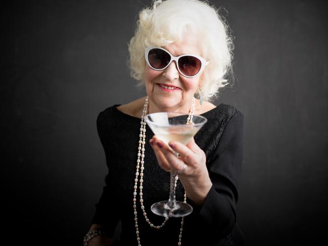 Cool grandma with sun glasses on having a drink. istock image