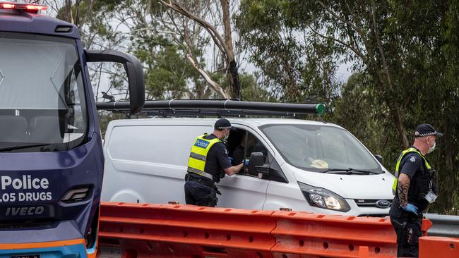 Police officers patrol and check for entry permits to Victoria at a border checkpoint in Mallacoota, Australia. Picture: Getty