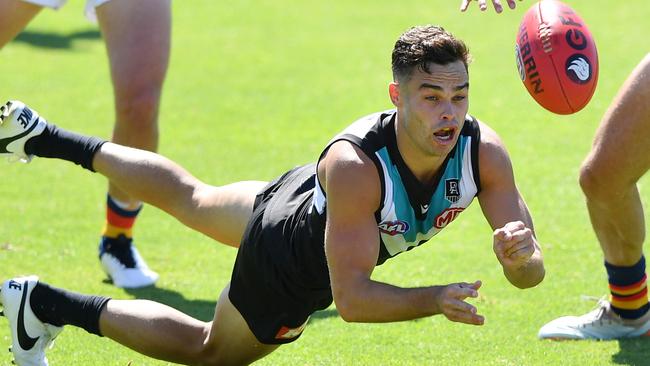 Karl Amon of Port Adelaide handballs during the AFL Practice Match between the Port Adelaide Power and the Adelaide Crows.