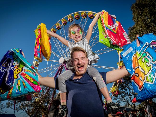 Royal Melbourne Show. Josh Carey and his niece Olivia Kolaitis, 7, load up with showbags. Picture: Jake Nowakowski