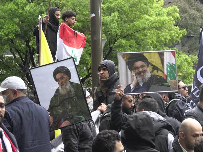 Protesters carry pictures of former Hezbollah leader Hassan Nasrallah through Melbourne. Picture: Valeriu Campan