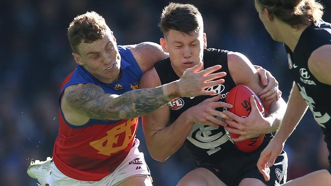 Sam Walsh is tackled by Mitch Robinson. Picture: Michael Klein