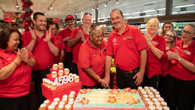 Cutting the cake at the Coles Cannonvale relaunch. Picture: Debbie Savy