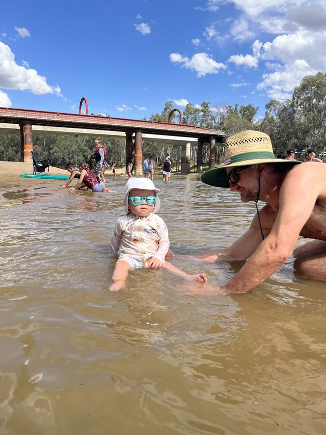 Keeping it cool with Daddy in the Murray River. Picture: Matthew Hoefnagels, Echuca.