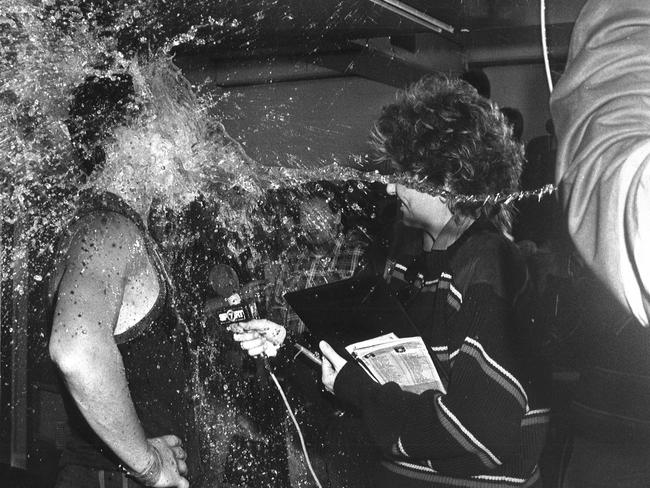 Marshall and Brian Wilson are showered with water by a club trainer during an interview.