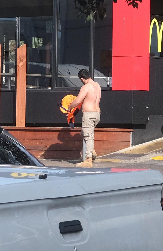 One of the men puts their shirt back on following the fight.