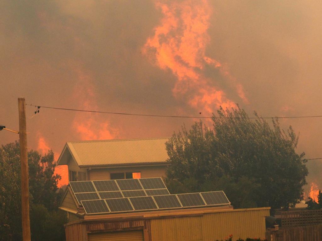 A bush fire rages in the town of Tathra on Sunday afternoon, March 18, 2018. Picture: John Ford