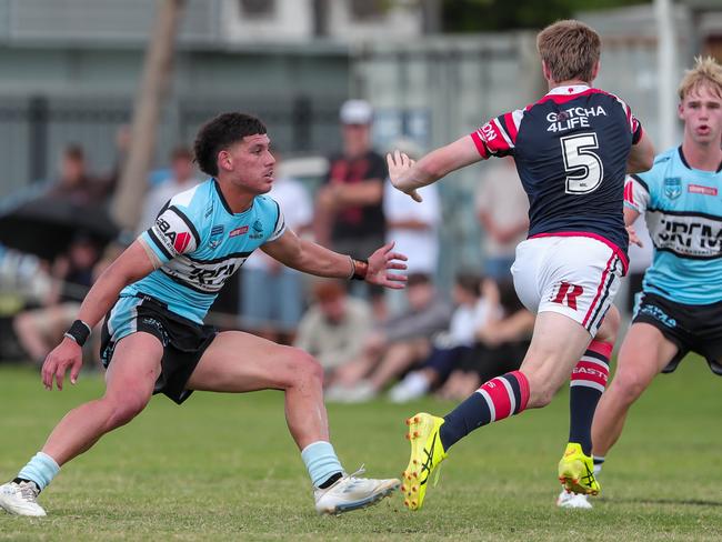 Cooper Moore sticks out the arm towards Spencer Swan as he makes a run. Picture: Adam Wrightson Photography