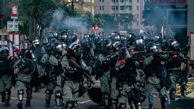 Riot police charge toward protesters during a demonstration in Wong Tai Sin district. Picture: Getty Images.