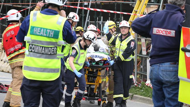 Emergency services transport a critically injured worker to hospital. Picture: David Caird