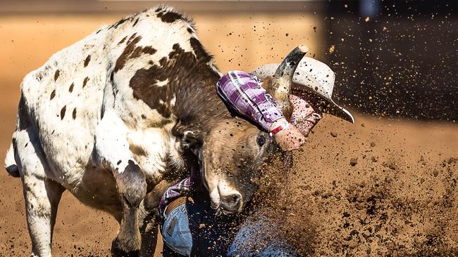 A Townsville based competitor wrestles in the Mount Isa Rodeo steer wrestling division. The rodeo is significant to the Mount Isa economy and is heralded as the greatest rodeo of the southern hemisphere. Picture: Stephen Mowbray Photography