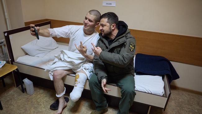 Zelensky poses for a picture with a wounded Ukrainian soldier in a hospital during his visit to Kharkiv.