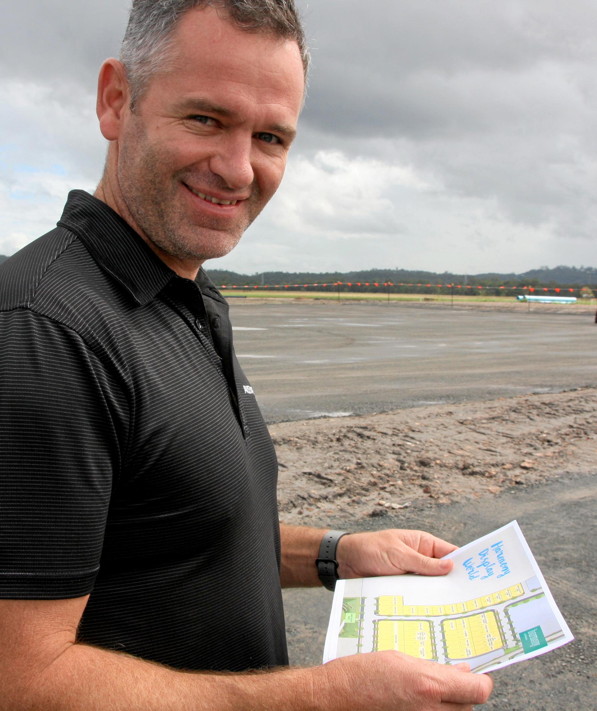 Ausmar's Josh Green checks the site map and get first look at the company's blocks of land in the new Harmony Display World at Palmview. Picture: Erle Levey