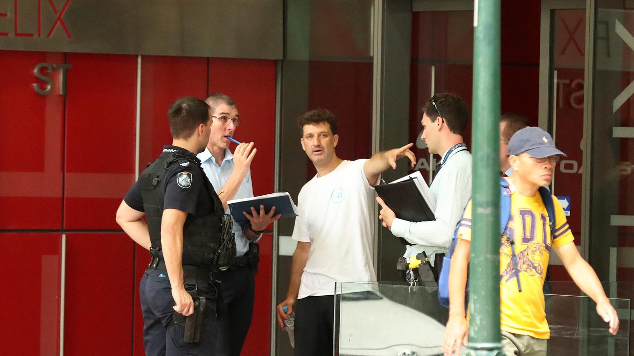 Detectives talking to a man on Felix Street, Police have created a crime scene blocking off Mary Street in front of the Westin hotel, Brisbane. Photographer: Liam Kidston.