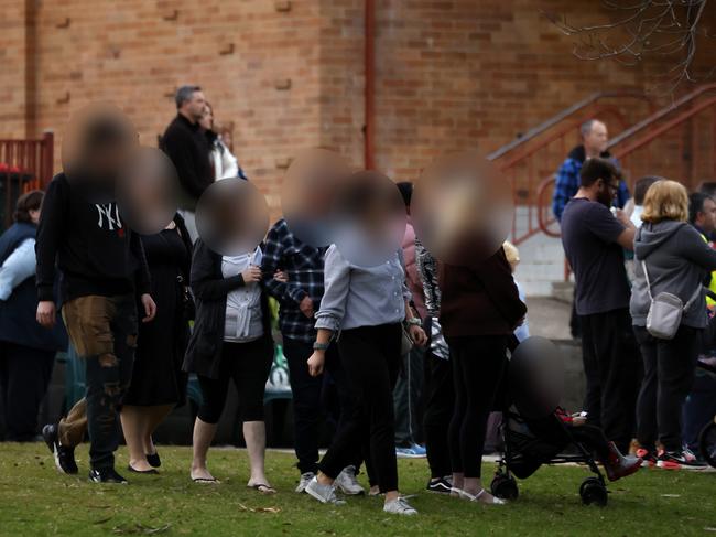 The mother of the children and family members arrive to join community members in Lalor Park at a gathering in their memory. Picture: Jonathan Ng