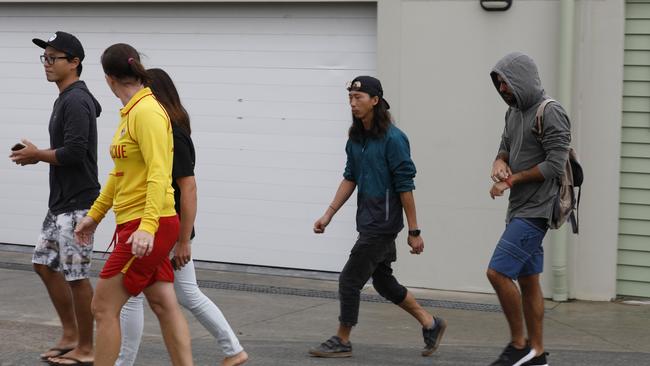 Friends of Tomoe Ogisu who drowned at Fingal Head brought flowers to Fingal Head Surf Life Saving Club the day his body was found.