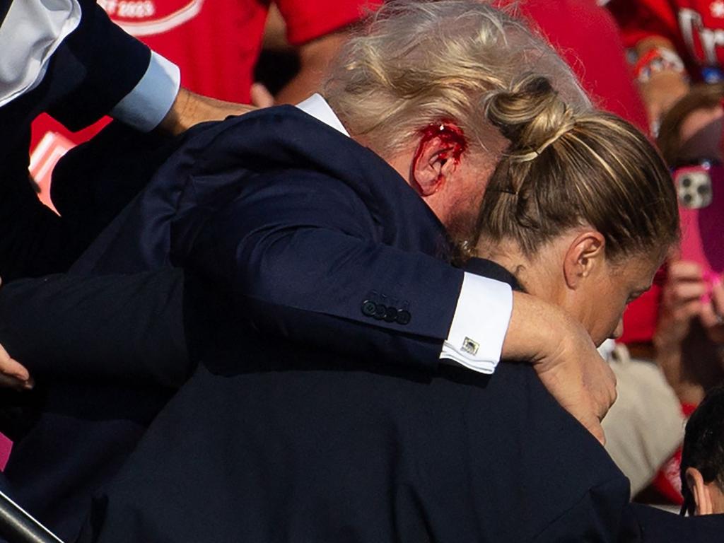 The former US President and Republican candidate had blood smeared across his face after a bullet grazed his ear. Picture: Rebecca DROKE/AFP