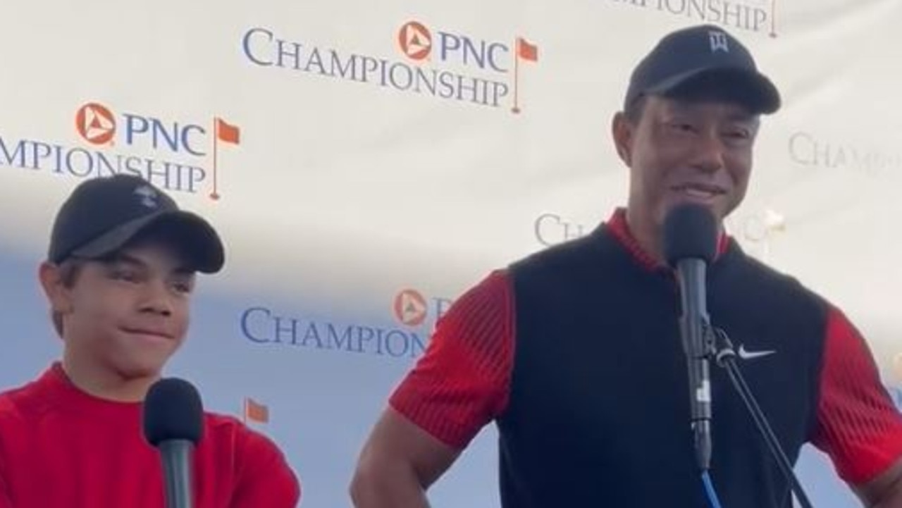 Charlie and Tiger Woods talk to media.