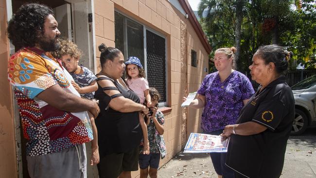 Lexy Carroll, the lead nurse at Yarrabah’s Gurriny Yealamucka Health Service, second from right, and indigenous health worker Adelaide Sand, right, visit the Pierce family to explain the benefits of vaccination. Picture Brian Cassey