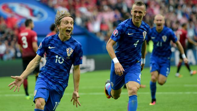 Croatia's midfielder Luka Modric (L) celebrates the team's first goal.