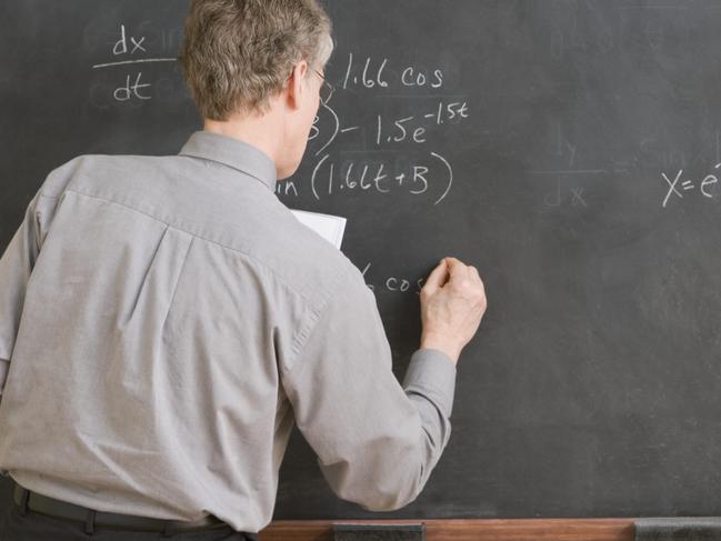 High School Teacher Writing Equation on Chalkboard