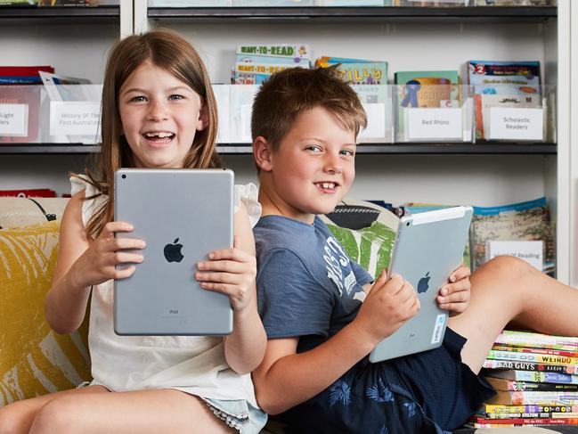 Elyse, 7 and Caleb, 6 pose for a picture at the Parks Library in Angle Park, where technology is being introduced, Thursday, March 14, 2019. Picture: MATT LOXTON