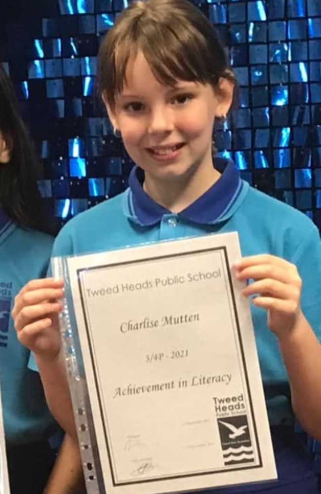 Charlise Mutten smiles at the camera and proudly holds up an award she received for achievement in literacy. It would be the last photograph taken of the nine-year-old at Tweed Heads Public School.