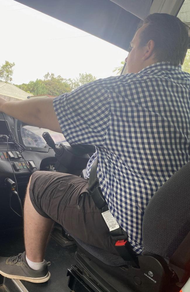 A Maryborough private school bus driver has been filmed appearing to check his mobile phone while driving.