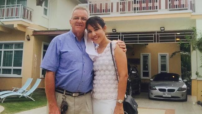 Andrew and Ning Fenwick smiling at the front of their house where the tragedy occurred.