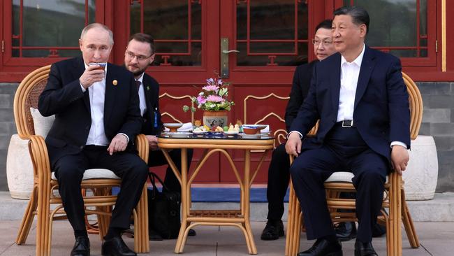 In this pool photograph distributed by the Russian state agency Sputnik, Russia's President Vladimir Putin and China's President Xi Jinping hold an informal meeting at Zhongnanhai leadership compound in Beijing in May. Picture: Pool/AFP