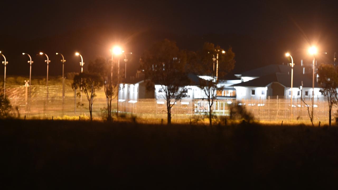 Police vehicles at the perimeter of the Capricornia Correctional Centre late on Thursday night during the riots and protests.